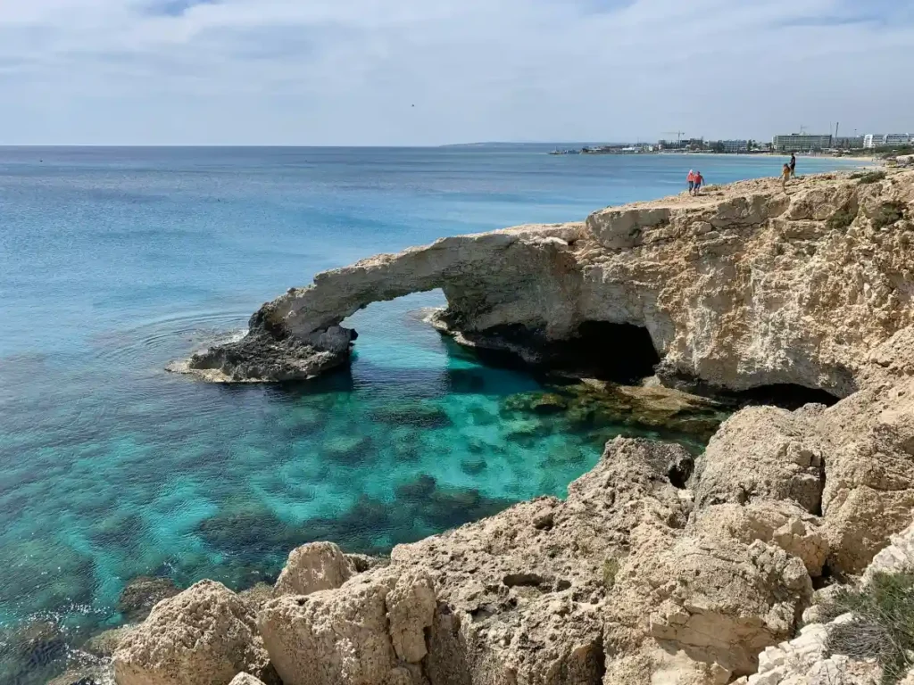 View of Ayia Napa beach with crystal-clear waters, vibrant nightlife, and historical landmarks.